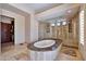 Luxurious bathroom featuring a marble-topped soaking tub, glass shower, and travertine tile at 4366 S Avenida De Angeles --, Gold Canyon, AZ 85118