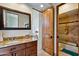 Bathroom boasts granite counters, vanity, mirror, and a shower/bath with tiled walls and glass door at 4366 S Avenida De Angeles --, Gold Canyon, AZ 85118