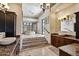 Luxurious bathroom with a step-up platform, soaking tub, dual sinks, and a view to the outside at 4366 S Avenida De Angeles --, Gold Canyon, AZ 85118