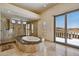 Bathroom showcasing a soaking tub, glass enclosed shower, and a sliding glass door to the outside at 4366 S Avenida De Angeles --, Gold Canyon, AZ 85118