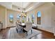 Formal dining room featuring hardwood floors, mountain views, a tray ceiling, and modern lighting at 4366 S Avenida De Angeles --, Gold Canyon, AZ 85118
