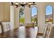 Dining room view highlighting the large dining table and outdoor views framed by arched windows at 4366 S Avenida De Angeles --, Gold Canyon, AZ 85118