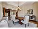 This dining room features a chandelier, wood table, and view to the living area at 4366 S Avenida De Angeles --, Gold Canyon, AZ 85118