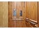 Custom wood-paneled elevator with functional controls and safety features for convenient home accessibility at 4366 S Avenida De Angeles --, Gold Canyon, AZ 85118