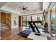 Bright exercise room with wood floors, mirrored wall, and sliding door access to the yard at 4366 S Avenida De Angeles --, Gold Canyon, AZ 85118