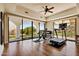 Bright exercise room with wood floors, ceiling fan, and sliding glass doors that open to the beautiful outdoors at 4366 S Avenida De Angeles --, Gold Canyon, AZ 85118