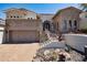 Charming home exterior featuring stone accents, a three-car garage, and a well-manicured landscape for curb appeal at 4366 S Avenida De Angeles --, Gold Canyon, AZ 85118