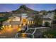 Elegant home with a tile roof, porte-cochere, and lush desert landscaping at dusk at 4366 S Avenida De Angeles --, Gold Canyon, AZ 85118
