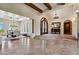 An expansive foyer with travertine tile floors and a grand arched entryway with wood beams at 4366 S Avenida De Angeles --, Gold Canyon, AZ 85118
