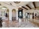 An open foyer showcases travertine floors, arched entryways, and wood beam accents at 4366 S Avenida De Angeles --, Gold Canyon, AZ 85118