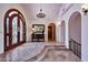 Elegant foyer features tile flooring, a decorative front door, and archways to other rooms at 4366 S Avenida De Angeles --, Gold Canyon, AZ 85118