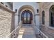 Elegant front entrance with custom wood doors, stone accents, and decorative iron railings leading up to the entrance at 4366 S Avenida De Angeles --, Gold Canyon, AZ 85118