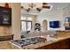 Gourmet kitchen with granite countertops, a gas range, and an open view to the living room at 4366 S Avenida De Angeles --, Gold Canyon, AZ 85118