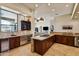 Elegant kitchen featuring dark wood cabinetry, a wine fridge, and granite countertops at 4366 S Avenida De Angeles --, Gold Canyon, AZ 85118