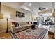 Open living room features a comfortable sectional sofa, ceiling fan, and access to the patio at 4366 S Avenida De Angeles --, Gold Canyon, AZ 85118