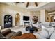 A beautiful living room features exposed wood beams and a stone fireplace, cozy and inviting at 4366 S Avenida De Angeles --, Gold Canyon, AZ 85118
