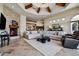 Open-concept living room with a stone fireplace, wood beam ceiling, and ample seating at 4366 S Avenida De Angeles --, Gold Canyon, AZ 85118