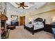 A spacious main bedroom features stone fireplace, tray ceiling, fan, and comfortable seating at 4366 S Avenida De Angeles --, Gold Canyon, AZ 85118
