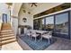 Covered patio with outdoor kitchen, dining table, and stairs to the backyard at 4366 S Avenida De Angeles --, Gold Canyon, AZ 85118