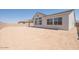 Spacious backyard with potential for landscaping and outdoor living with covered patio and privacy wall at 4822 W Owl Head Pl, San Tan Valley, AZ 85144
