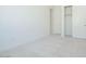Well-lit bedroom with plush carpet and a convenient closet at 4822 W Owl Head Pl, San Tan Valley, AZ 85144