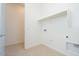Functional laundry room features tile floor and shelving for storage at 4822 W Owl Head Pl, San Tan Valley, AZ 85144