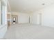 Bright, open-concept living room with neutral carpet and recessed lighting at 4822 W Owl Head Pl, San Tan Valley, AZ 85144