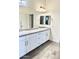 Bright bathroom with double vanity, gray countertops and modern finishes, and wood look tile flooring at 4956 S Leisure Way, Gilbert, AZ 85298