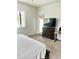 Bedroom featuring a bed, dresser, TV, and a door to an outdoor patio at 4956 S Leisure Way, Gilbert, AZ 85298