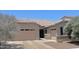 Charming single-story home featuring a paved driveway, attached garage, and desert landscaping at 4956 S Leisure Way, Gilbert, AZ 85298
