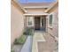 Inviting front entryway with a dark wood door, neutral paint, decorative stone accents and drought-tolerant landscaping at 4956 S Leisure Way, Gilbert, AZ 85298