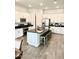 Spacious kitchen showcasing an island with bar stool seating, white cabinetry, and modern appliances at 4956 S Leisure Way, Gilbert, AZ 85298
