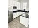 Modern kitchen with white cabinets, stainless steel appliances, and granite countertops for a sleek, functional space at 4956 S Leisure Way, Gilbert, AZ 85298