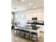 Modern kitchen featuring white cabinets, stainless steel appliances, and a large island with seating at 4956 S Leisure Way, Gilbert, AZ 85298