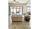 Bright living room featuring neutral decor, tile floors, and a sliding glass door leading to the patio at 4956 S Leisure Way, Gilbert, AZ 85298