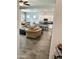 Open-concept living space with tile flooring and neutral decor connecting kitchen, living and dining areas at 4956 S Leisure Way, Gilbert, AZ 85298