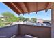 Balcony with view of parking lot and surrounding greenery under a clear blue sky at 5757 W Eugie Ave # 2068, Glendale, AZ 85304