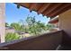 Balcony shot shows view of green landscaping, trees, and nearby parking lot at 5757 W Eugie Ave # 2068, Glendale, AZ 85304