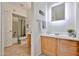 Well-lit bathroom with wood vanity, illuminated mirror, and separate toilet and shower area at 5757 W Eugie Ave # 2068, Glendale, AZ 85304