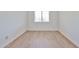 Neutral bedroom with wood-look flooring, a single window, and white walls at 5757 W Eugie Ave # 2068, Glendale, AZ 85304