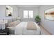 A calm bedroom featuring natural light, comfortable bedding and stylish wall art at 5757 W Eugie Ave # 2068, Glendale, AZ 85304