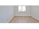 Bright bedroom with wood flooring, baseboards, and natural light streaming through the window at 5757 W Eugie Ave # 2068, Glendale, AZ 85304