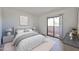 Serene bedroom with neutral tones, featuring a sliding glass door to a balcony at 5757 W Eugie Ave # 2068, Glendale, AZ 85304