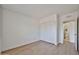 A cozy bedroom featuring wood floors, closet space, and an open doorway to the bathroom at 5757 W Eugie Ave # 2068, Glendale, AZ 85304