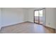 Empty bedroom with wood-look flooring and a sliding glass door to the outside at 5757 W Eugie Ave # 2068, Glendale, AZ 85304