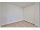 A bright bedroom with wood flooring, baseboards, and a spacious closet for storage at 5757 W Eugie Ave # 2068, Glendale, AZ 85304