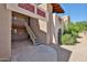 Condominium building exterior featuring a staircase with a white railing at 5757 W Eugie Ave # 2068, Glendale, AZ 85304