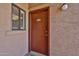 Condo front door with unit number, sidelight window, and tan exterior at 5757 W Eugie Ave # 2068, Glendale, AZ 85304