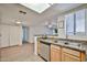 Kitchen view opens to living space, showing granite countertops and stainless steel dishwasher at 5757 W Eugie Ave # 2068, Glendale, AZ 85304