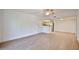 Bright living room with wood-look flooring, neutral paint, and adjacent kitchen at 5757 W Eugie Ave # 2068, Glendale, AZ 85304